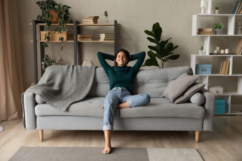 Image of someone sitting back on their couch. How a Whole-House Humidifier Keeps You Healthy.